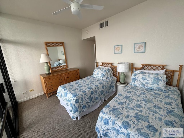 bedroom with dark colored carpet and ceiling fan