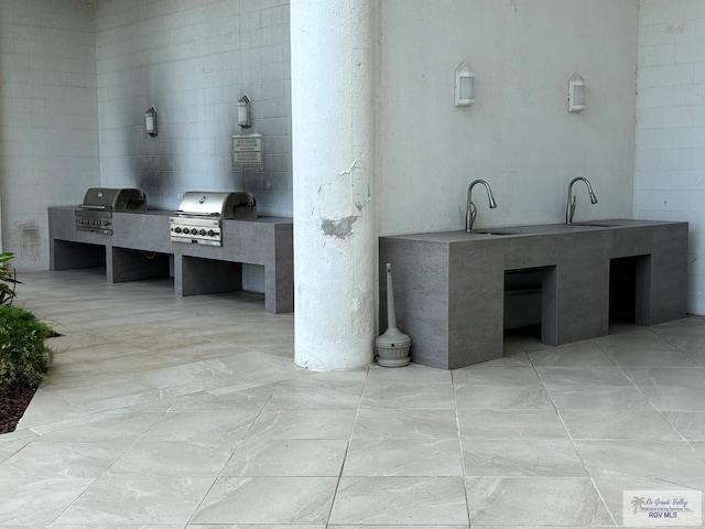 interior space with marble finish floor and a sink