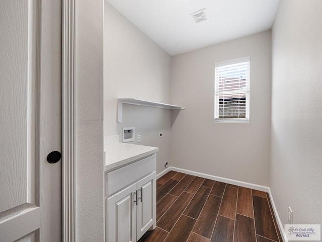 23756 Richmond Cir, Harlingen, TX 78552 - washroom featuring electric dryer hookup, washer hookup, dark wood-type flooring, and cabinet space