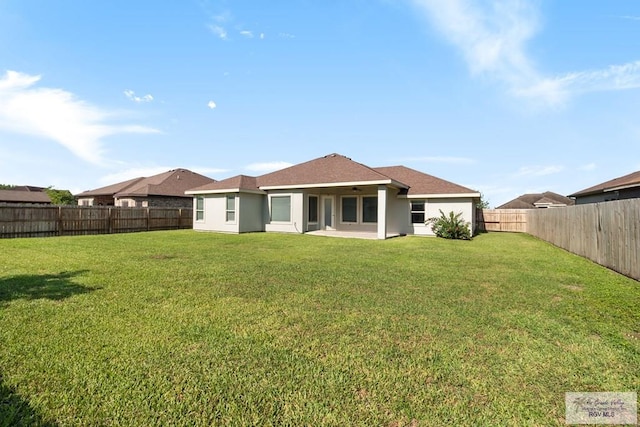 23756 Richmond Cir, Harlingen, TX 78552 - back of house with a fenced backyard and stucco siding