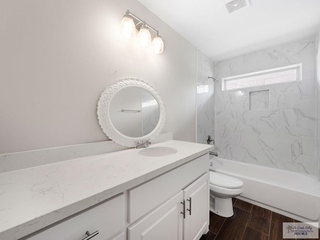 23756 Richmond Cir, Harlingen, TX 78552 - bathroom featuring vanity, washtub / shower combination, and wood finished floors