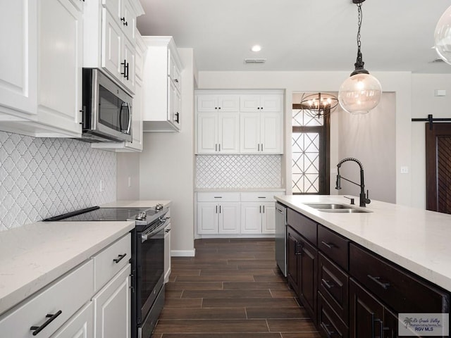 23756 Richmond Cir, Harlingen, TX 78552 - kitchen featuring appliances with stainless steel finishes, dark wood-style flooring, decorative backsplash, white cabinetry, and light stone counters