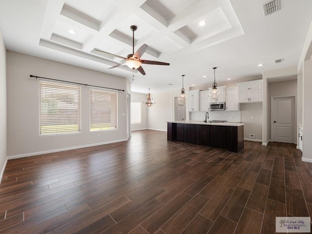 23756 Richmond Cir, Harlingen, TX 78552 - unfurnished living room featuring a ceiling fan, recessed lighting, coffered ceiling, beam ceiling, and dark wood-type flooring