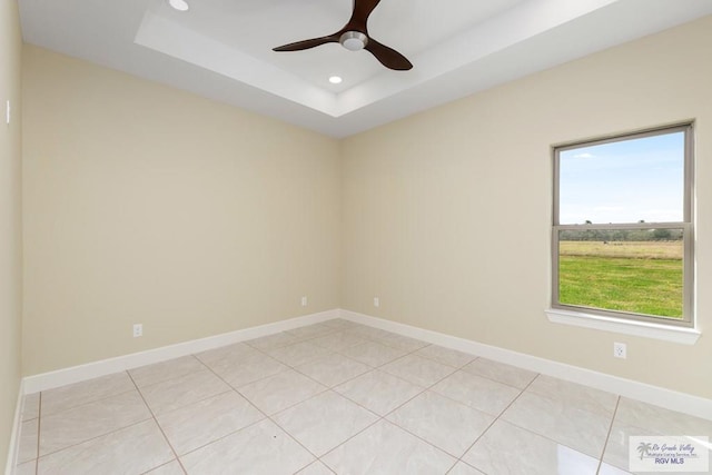 1902 Thacker Ln, Harlingen, TX 78552 - unfurnished room with ceiling fan, recessed lighting, a tray ceiling, and light tile patterned floors