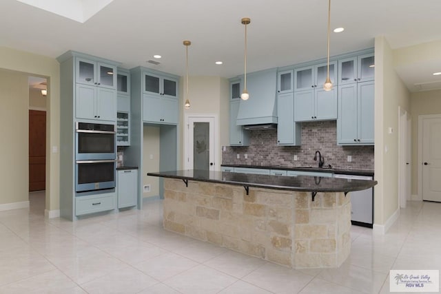 1902 Thacker Ln, Harlingen, TX 78552 - kitchen with appliances with stainless steel finishes, decorative backsplash, light tile patterned flooring, a breakfast bar, and recessed lighting