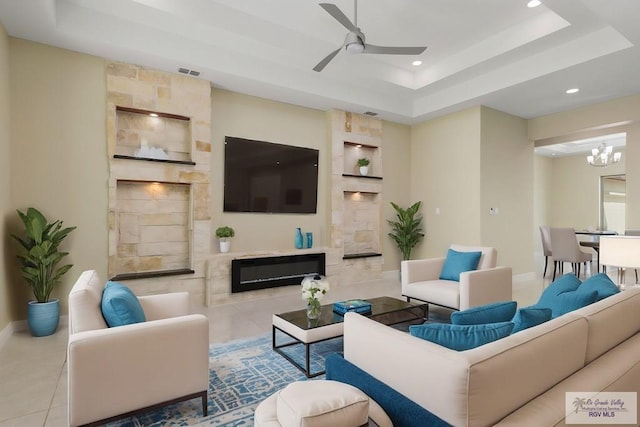 1902 Thacker Ln, Harlingen, TX 78552 - living area with a raised ceiling, recessed lighting, ceiling fan, a glass covered fireplace, and a chandelier