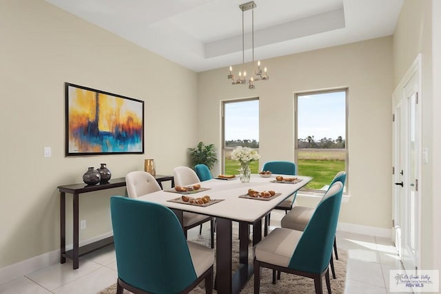 1902 Thacker Ln, Harlingen, TX 78552 - dining space featuring light tile patterned flooring, a chandelier, and a tray ceiling