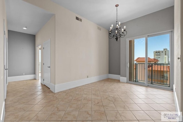 201 W Capricorn Dr, South Padre Island, TX 78597 - unfurnished room featuring a chandelier, baseboards, and light tile patterned floors