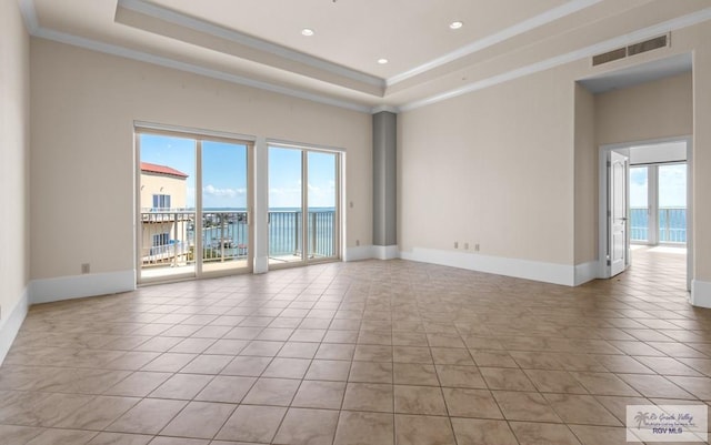201 W Capricorn Dr, South Padre Island, TX 78597 - spare room featuring a raised ceiling, crown molding, baseboards, light tile patterned floors, and recessed lighting