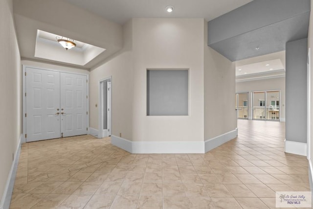 201 W Capricorn Dr, South Padre Island, TX 78597 - foyer featuring a raised ceiling, baseboards, and recessed lighting