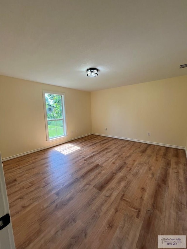 spare room featuring hardwood / wood-style flooring