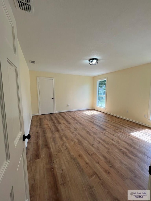 spare room with hardwood / wood-style flooring