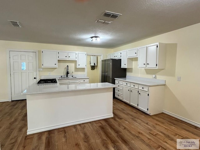 kitchen featuring white cabinetry, sink, appliances with stainless steel finishes, and dark wood-type flooring