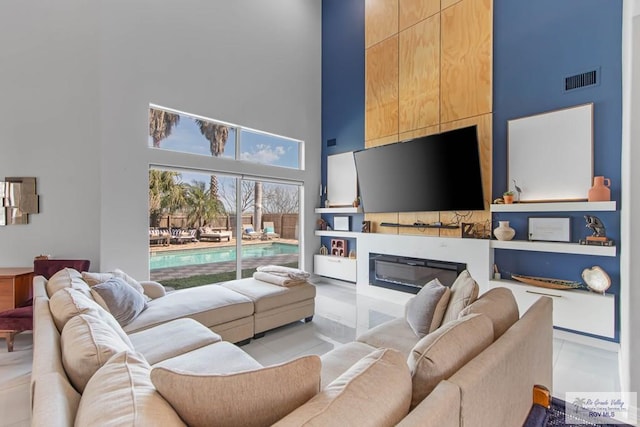 tiled living room with a towering ceiling