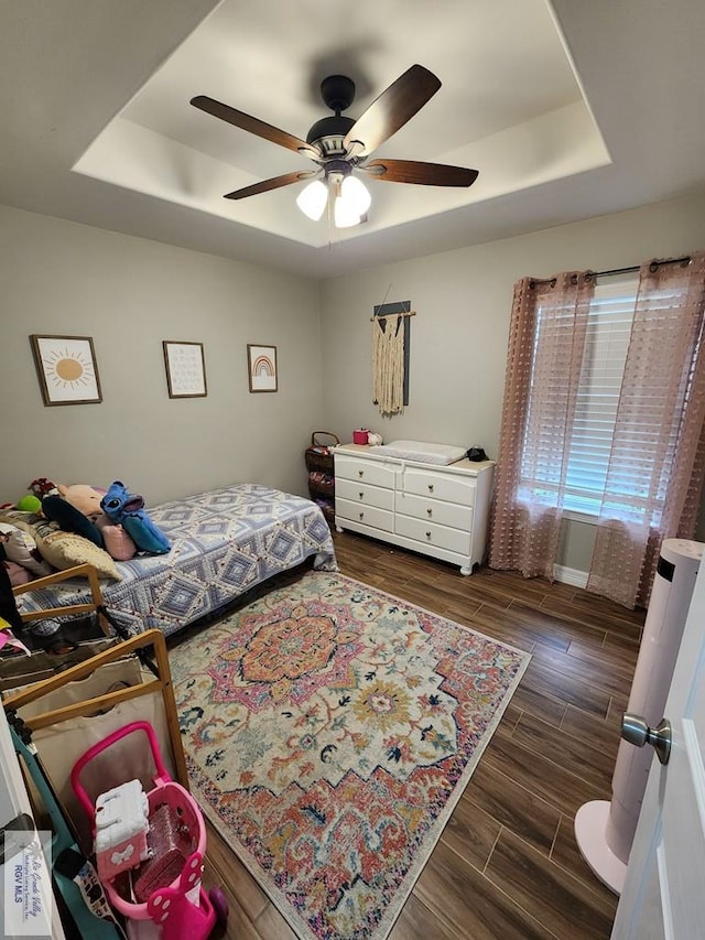 bedroom featuring ceiling fan and a tray ceiling