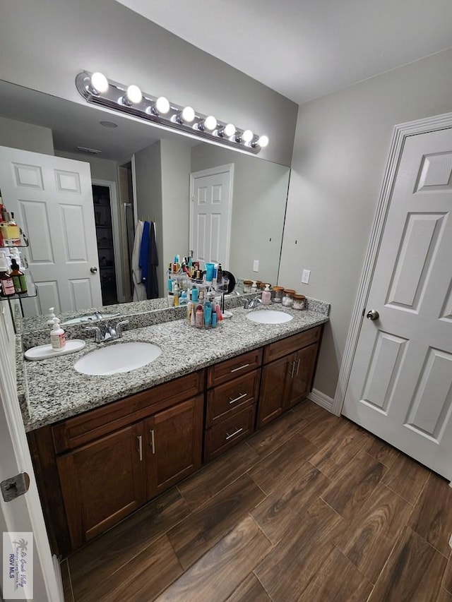 bathroom with vanity and hardwood / wood-style floors