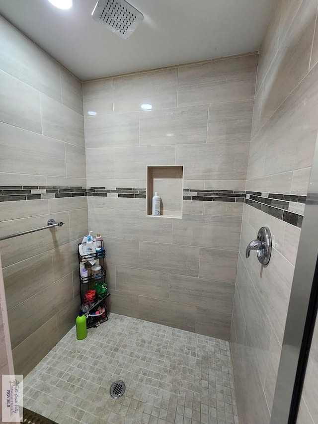 bathroom with tiled shower