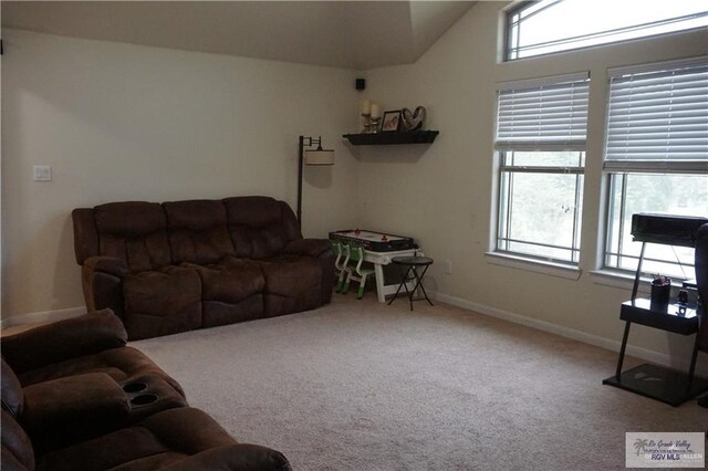 living room with carpet, plenty of natural light, and lofted ceiling