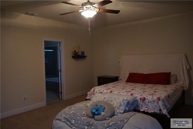 carpeted bedroom with ensuite bathroom and ceiling fan