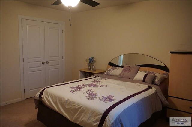 carpeted bedroom featuring ceiling fan and a closet