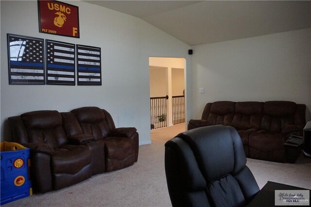 carpeted living room with vaulted ceiling