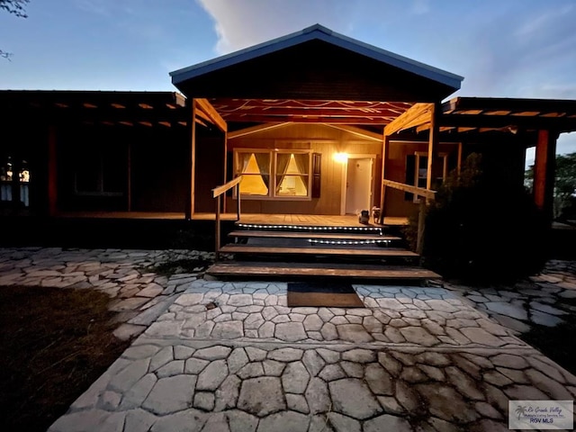 view of back house at dusk