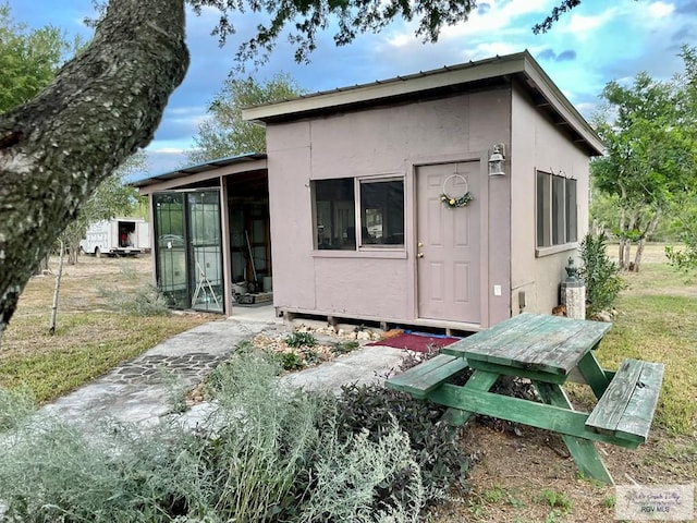 back of property featuring a lawn