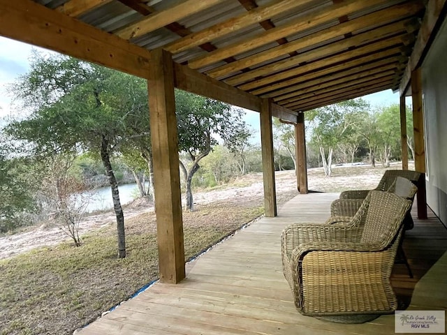 exterior space with a deck with water view