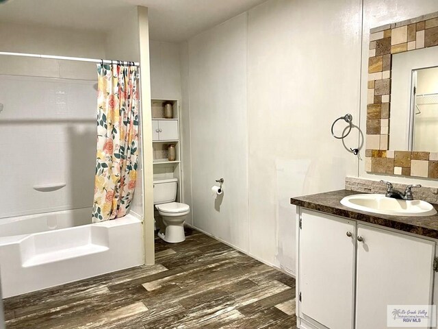 full bathroom with toilet, shower / bath combo with shower curtain, vanity, and hardwood / wood-style flooring