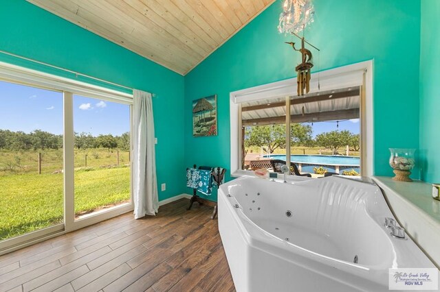 25096 Rabb Rd, La Feria, TX 78559 - bathroom with lofted ceiling, wooden ceiling, a tub with jets, and wood finished floors