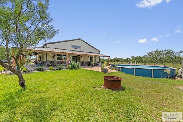 25096 Rabb Rd, La Feria, TX 78559 - back of property featuring a yard, an outdoor pool, and a patio area