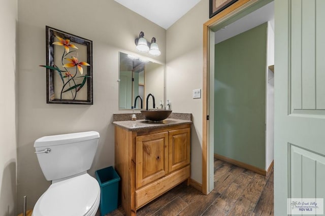 25096 Rabb Rd, La Feria, TX 78559 - half bathroom featuring vanity and wood finished floors