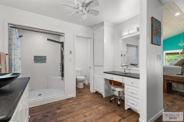 25096 Rabb Rd, La Feria, TX 78559 - full bath featuring wood finished floors, a shower stall, ceiling fan, vanity, and vaulted ceiling