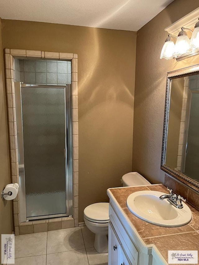 901 Morelos Ave, Rancho Viejo, TX 78575 - bathroom with vanity, tile patterned flooring, and a stall shower