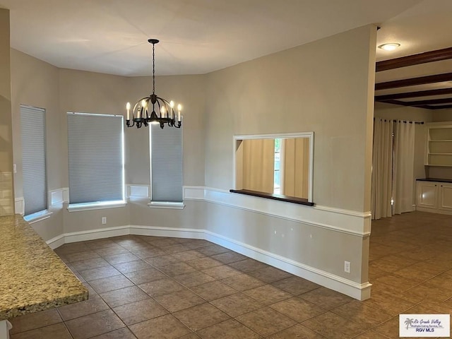 901 Morelos Ave, Rancho Viejo, TX 78575 - unfurnished dining area with a chandelier and tile patterned floors