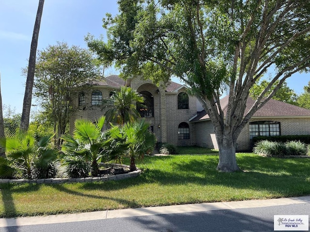 901 Morelos Ave, Rancho Viejo, TX 78575 - view of front of house featuring brick siding and a front yard