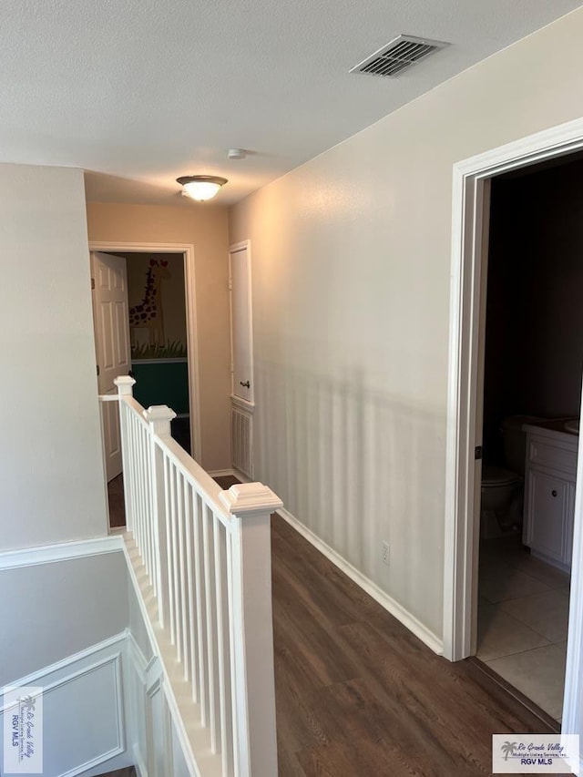 901 Morelos Ave, Rancho Viejo, TX 78575 - corridor featuring an upstairs landing and dark wood finished floors