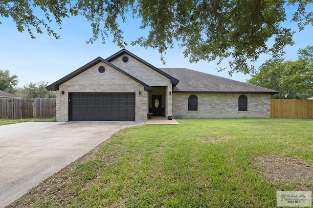 313 Scarlett Cir, Harlingen, TX 78552 - french country inspired facade with an attached garage, driveway, and brick siding