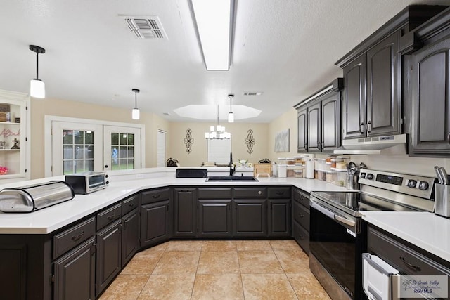 313 Scarlett Cir, Harlingen, TX 78552 - kitchen featuring stainless steel range with electric stovetop, under cabinet range hood, a chandelier, and light countertops