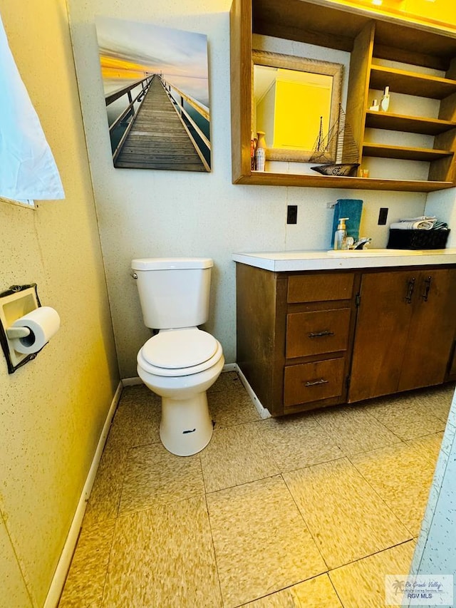 bathroom with tile patterned floors, vanity, and toilet