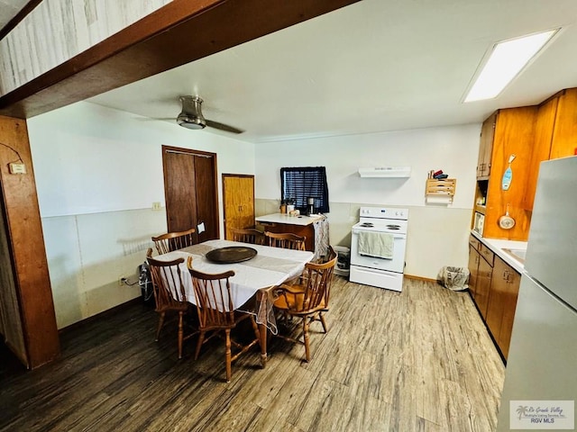 dining area featuring ceiling fan and wood-type flooring