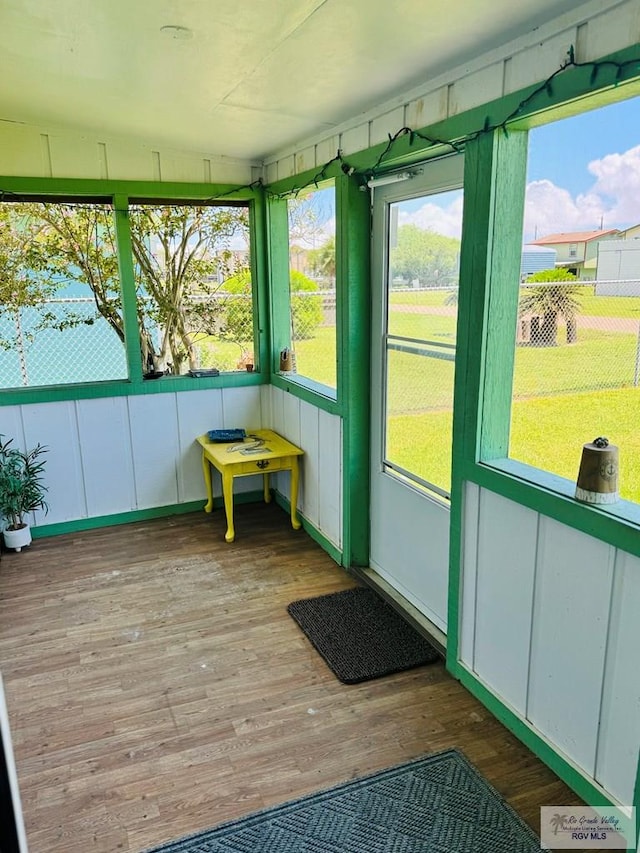 sunroom / solarium featuring lofted ceiling