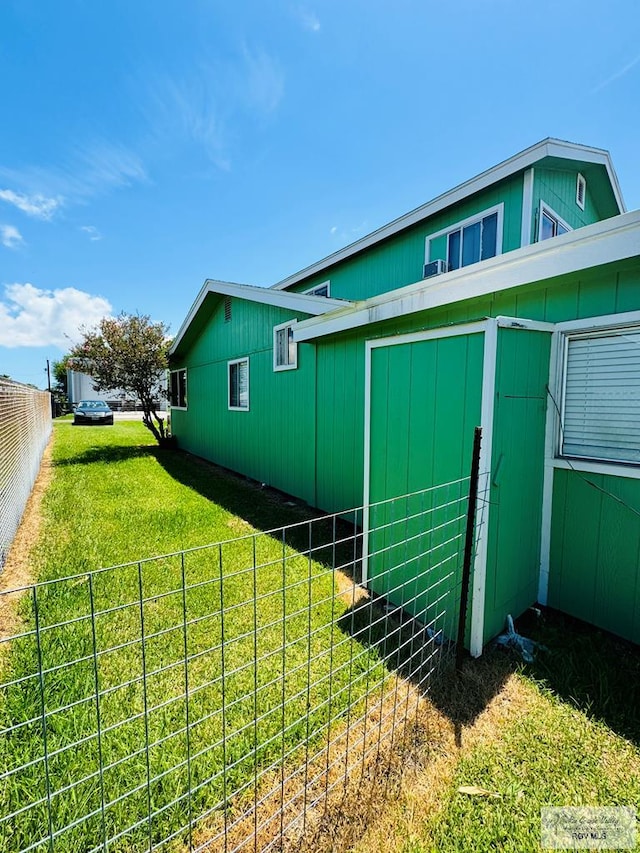 view of side of property featuring a yard