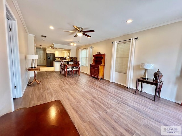 40 Cherokee Ave, Harlingen, TX 78552 - living room featuring ceiling fan, ornamental molding, light wood-style flooring, and recessed lighting