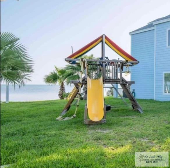 view of playground with a lawn and a water view