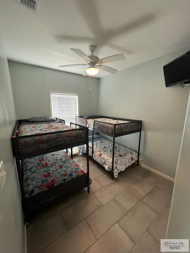 tiled bedroom with ceiling fan