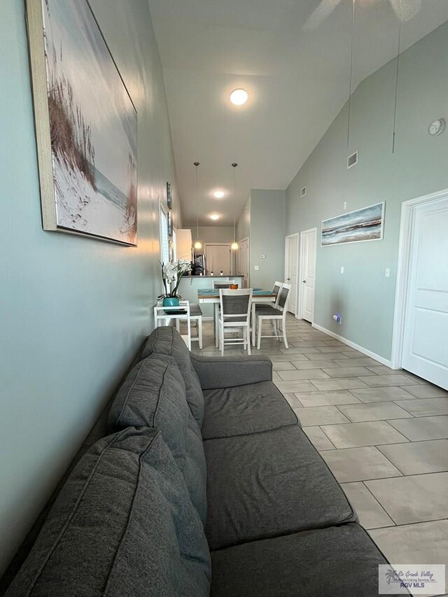 tiled living room with high vaulted ceiling