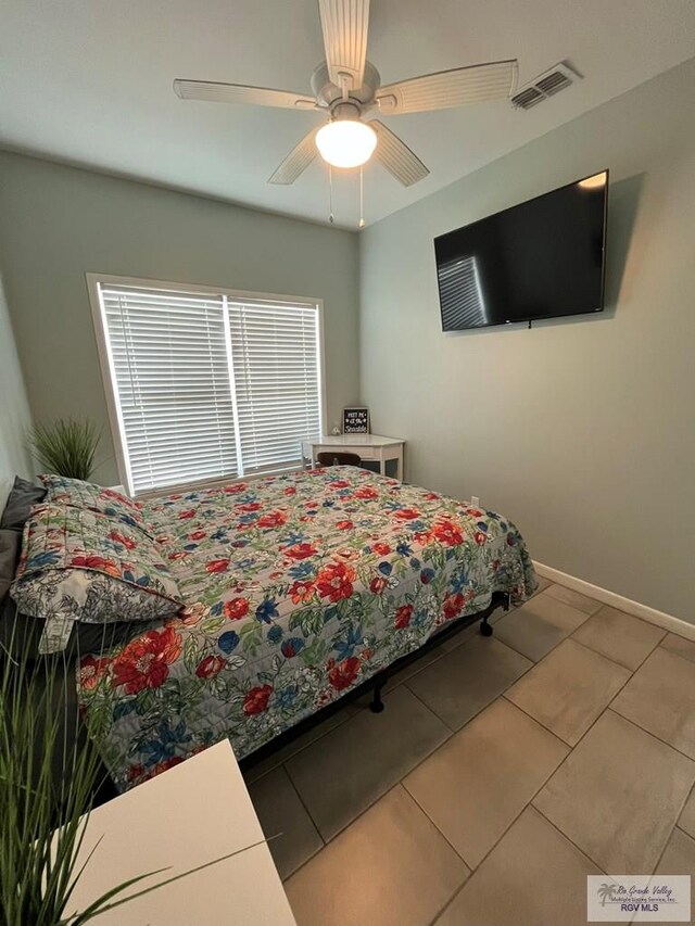 tiled bedroom with ceiling fan