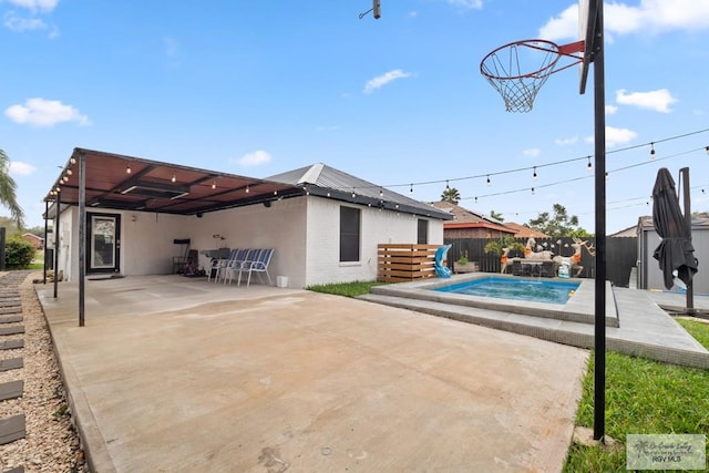 exterior space featuring a patio area and a fenced in pool