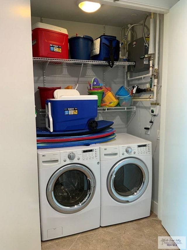 laundry area with tile patterned flooring and washer and dryer